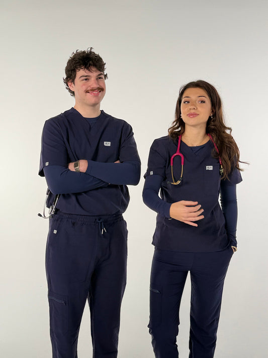 2 dentists wearing navy blue nila scrubs, happy with their decision to buy nila