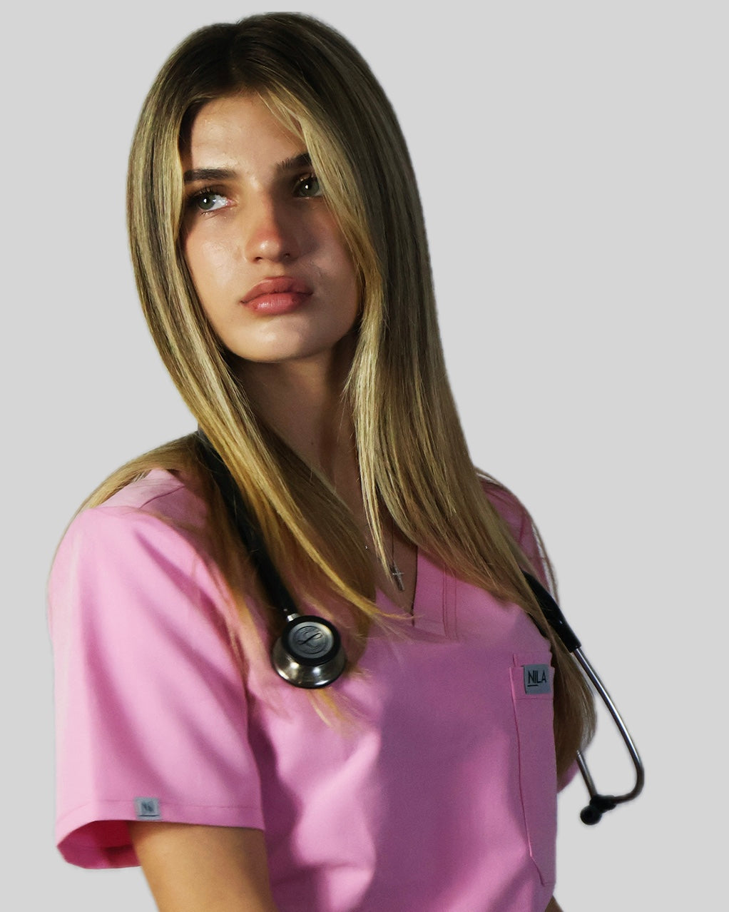 medical student wearing nila scrubs for women in blush pink