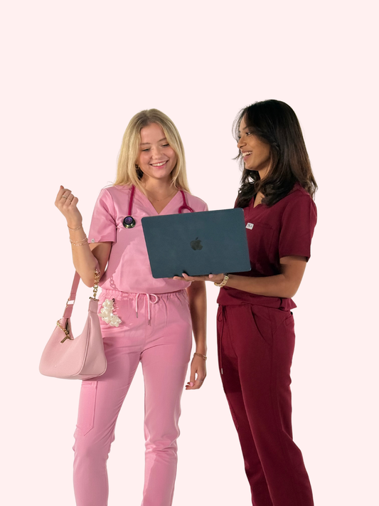 2 medical students on medical rotations wearing nila scrubs in blush pink and wine red
