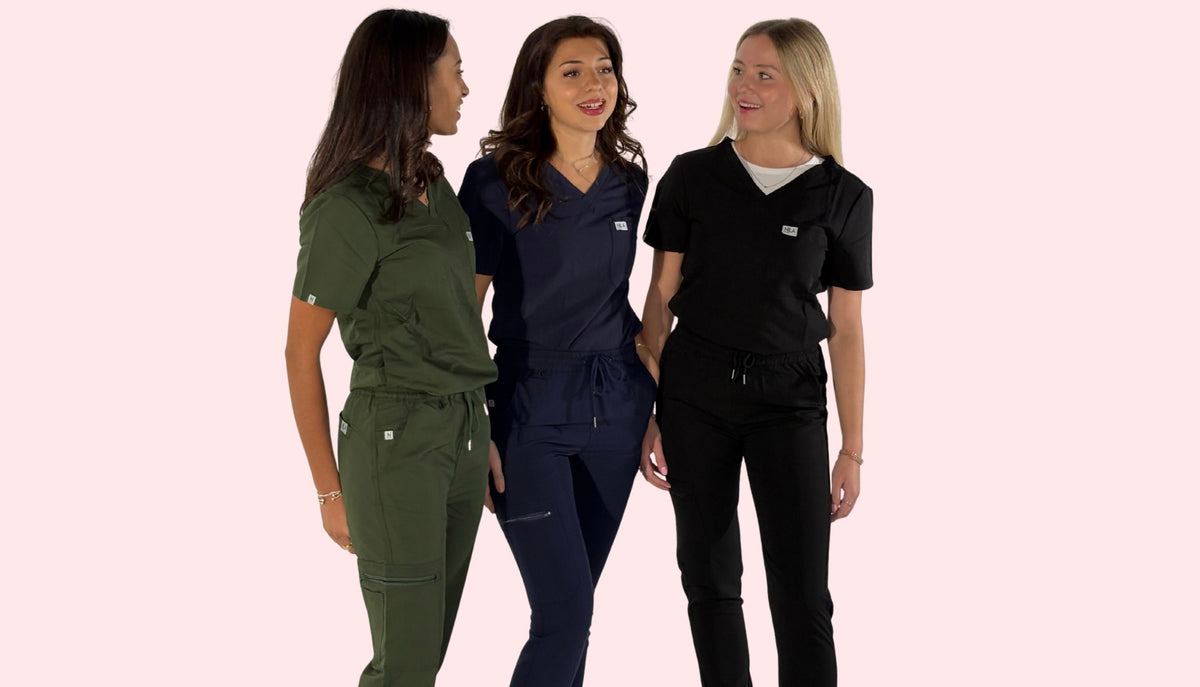group of dentists wearing nila scrubs sets for women in forest green, navy, and black.