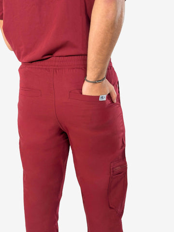 Men’s wine red Nila Scrubs medical scrub trousers back pocket detail worn by a healthcare professional